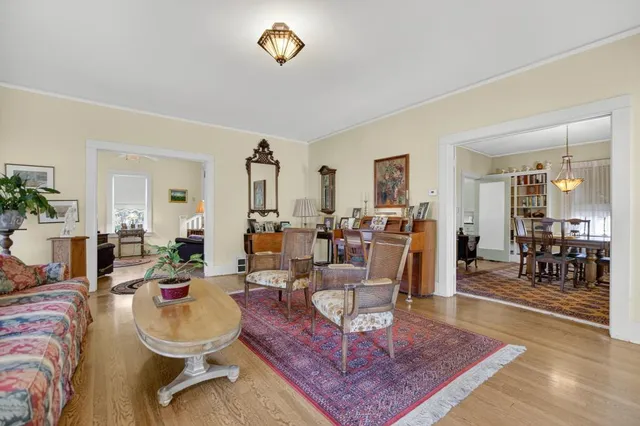 a living room with furniture a flat screen tv and a large window