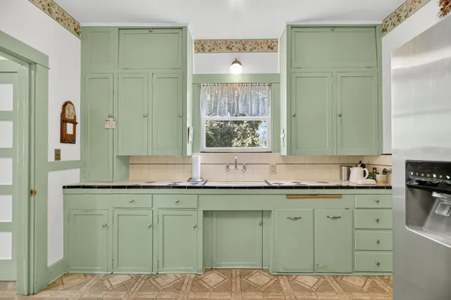 a kitchen with stainless steel appliances granite countertop a refrigerator and a stove