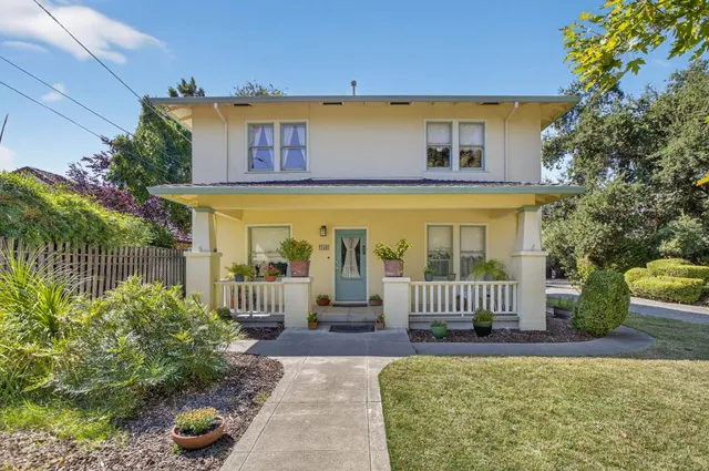 a front view of a house with a garden