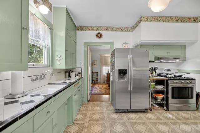 a view of a bedroom with a large window and front door