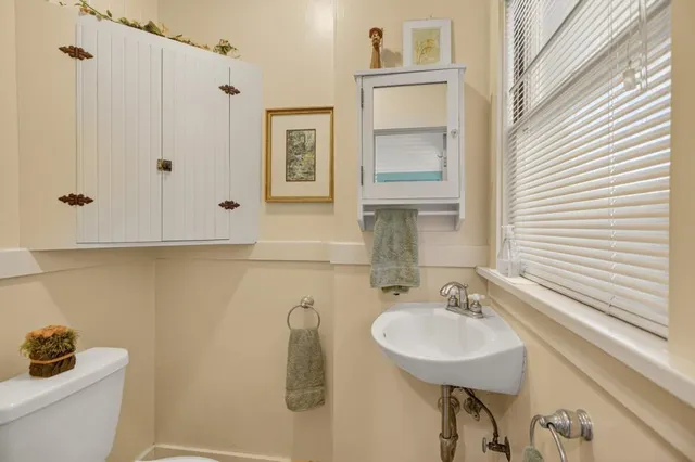 a living room with furniture and a book shelf