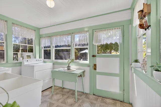 a view of a hallway with wooden floor and windows