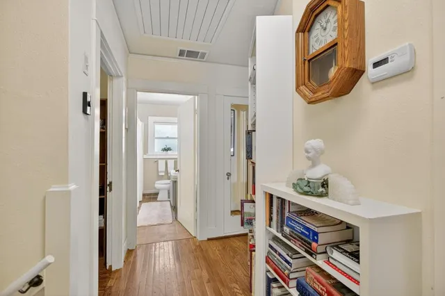 a view of a workspace with furniture and wooden floor