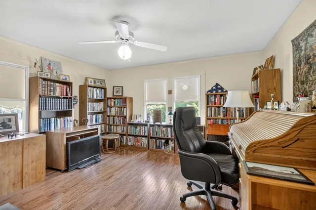 a view of a house with a tree and pathway