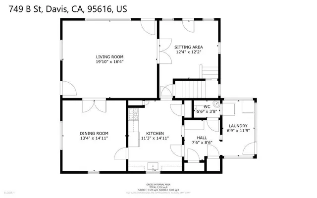 a living room with furniture a rug and kitchen view
