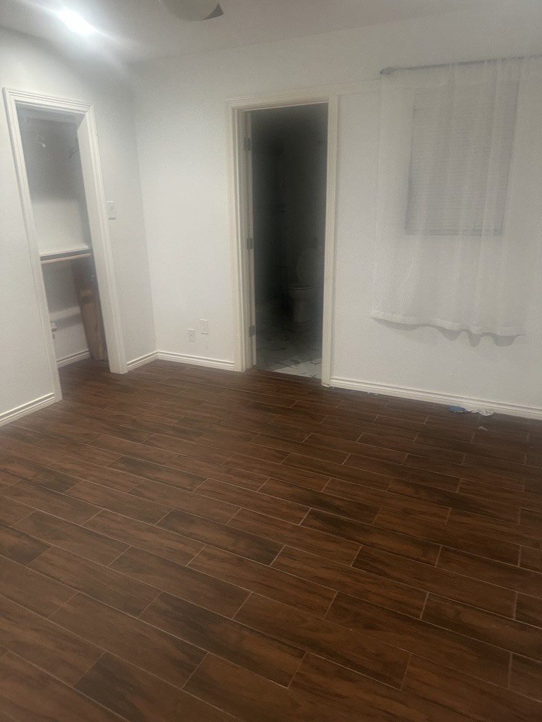 304 Jill Street Conroe, TX 77303 - Photo 19 of 35 a view of an empty room with wooden floor
