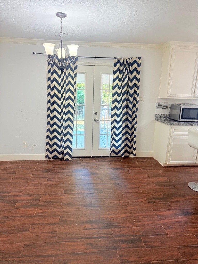 304 Jill Street Conroe, TX 77303 - Photo 2 of 35 a view of an empty room with wooden floor