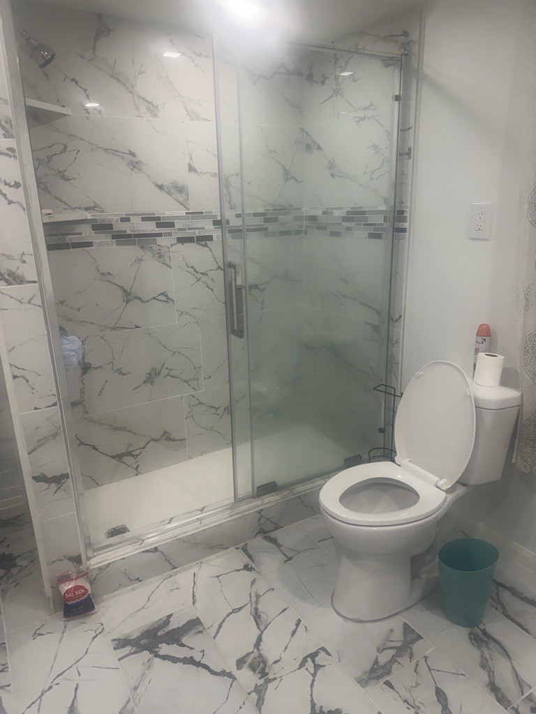 304 Jill Street Conroe, TX 77303 - Photo 21 of 35 a bathroom with a toilet and a shower