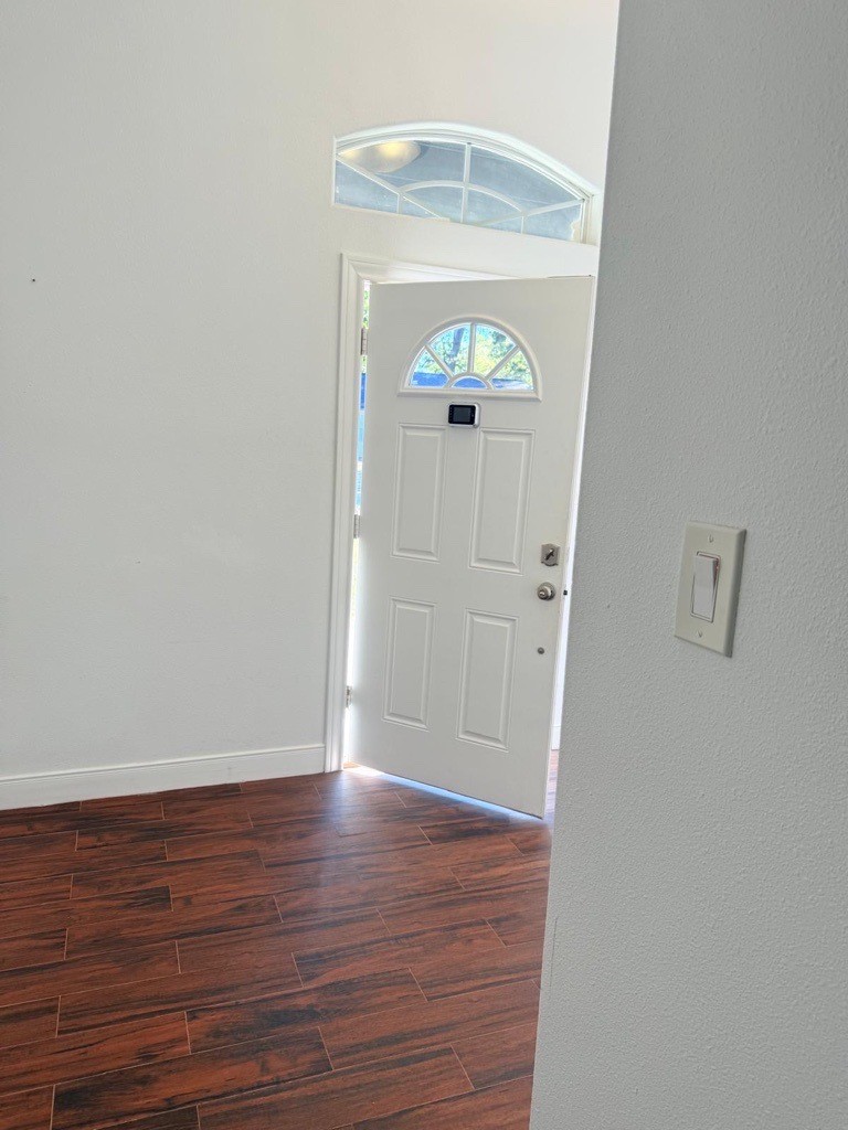 304 Jill Street Conroe, TX 77303 - Photo 35 of 35 an empty room with wooden floor and mirror