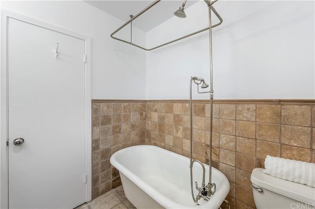 a bedroom with a bed furniture and windows