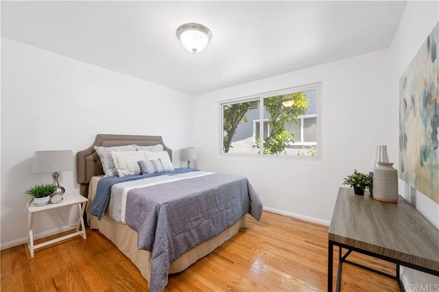 a living room with furniture potted plant and a large window