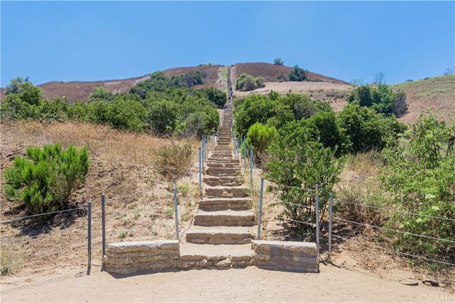 a view of a dry yard with mountains in the background