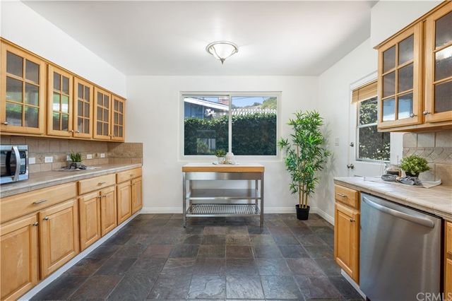 a kitchen with granite countertop a sink and cabinets