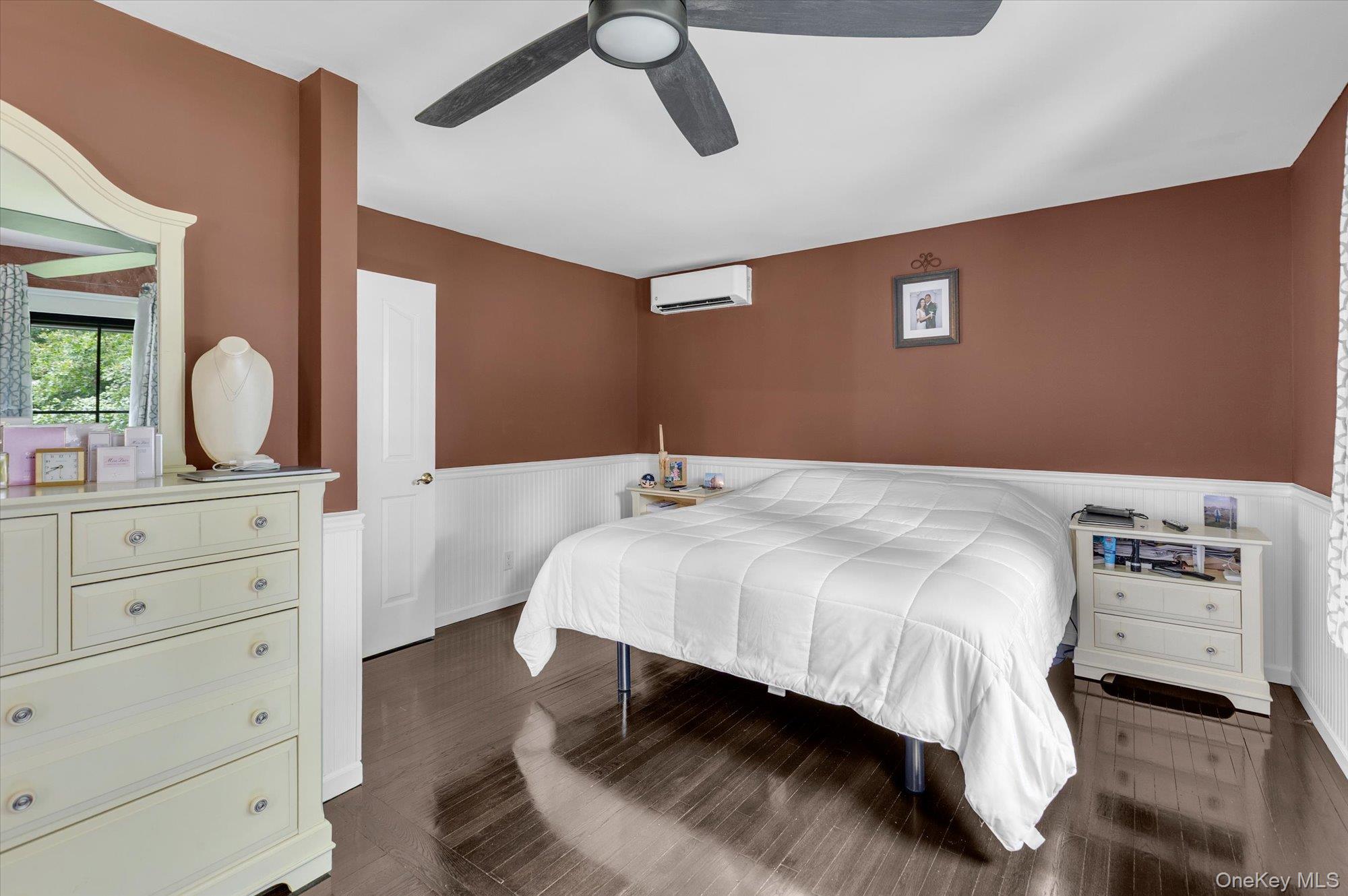 31 Apple Lane Commack, NY 11725 - Photo 10 of 28 Wood flooring, modern ceiling fan and bead board wainscoting detail.
