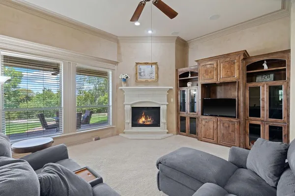 a living room with furniture a flat screen tv and a fireplace