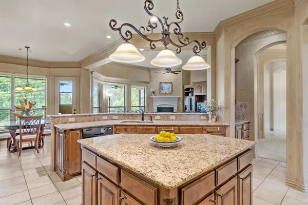 a kitchen with a table a sink and cabinets