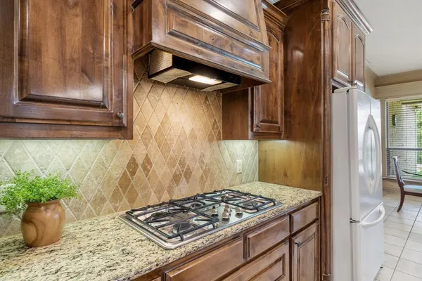 a stove top oven sitting inside of a kitchen
