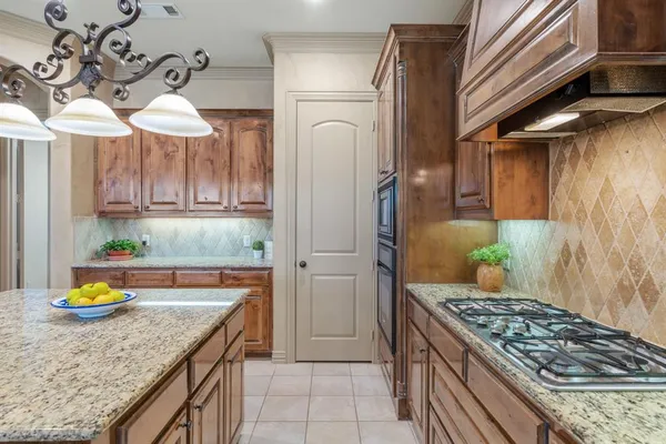 a kitchen with stainless steel appliances granite countertop a stove and a cabinets
