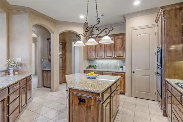 a kitchen with refrigerator cabinets and stove