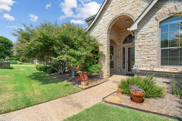 a view of a house with a backyard and a garden