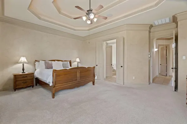a bedroom with a bed and a chandelier