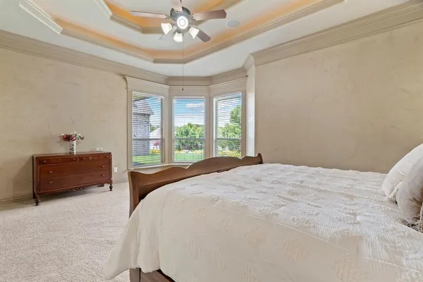 a bedroom with a bed and a chandelier