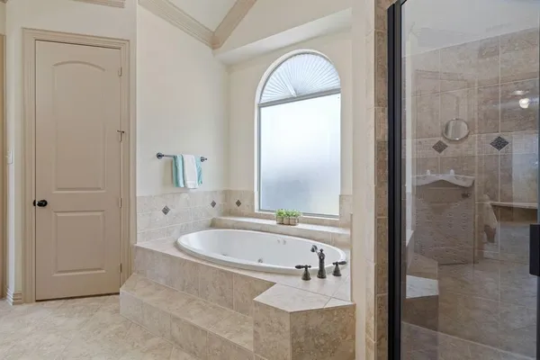 a bathroom with a tub sink and mirror