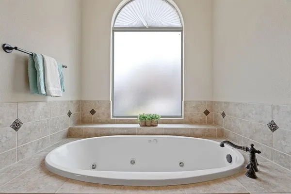 a bathroom with a tub and a shower