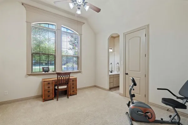 a view of a workspace with furniture and a window