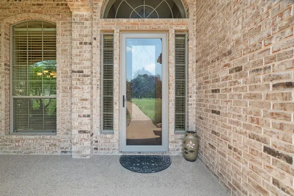 a view of a door and chair in the balcony