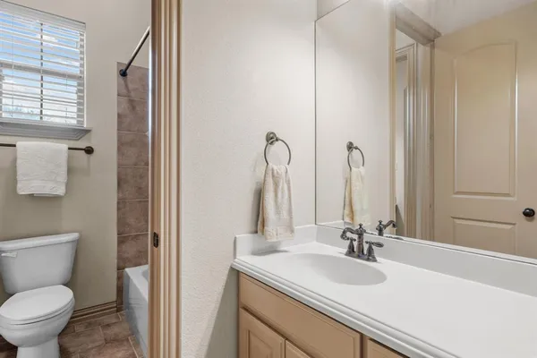 a bathroom with a sink toilet and mirror