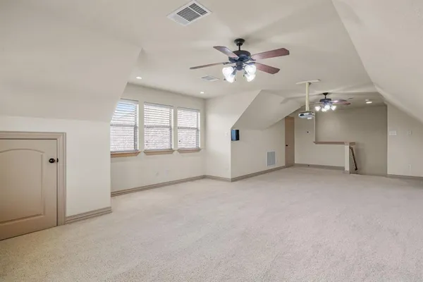 a view of a livingroom with a ceiling fan and window
