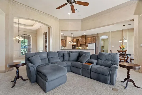 a living room with furniture and a dining table