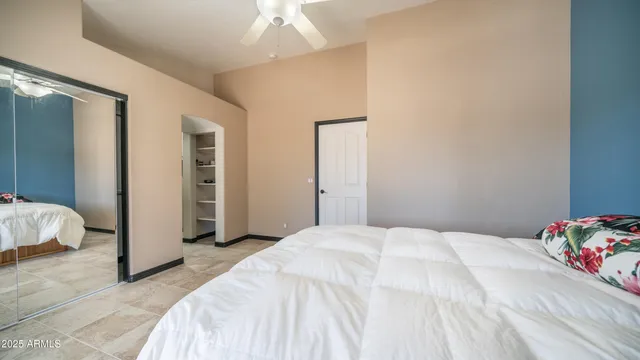 a bedroom with a bed and a chandelier