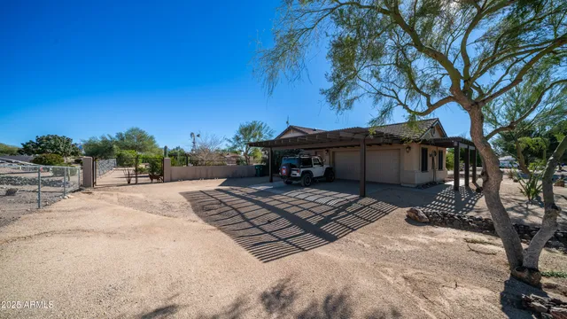 a view of a backyard with plants and swimming pool