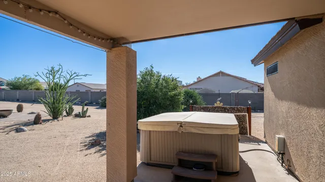 a view of a patio with a table and chairs next to a yard