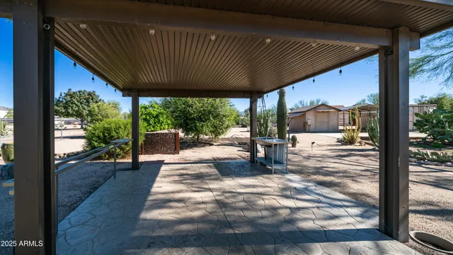 a view of backyard with seating space and trees