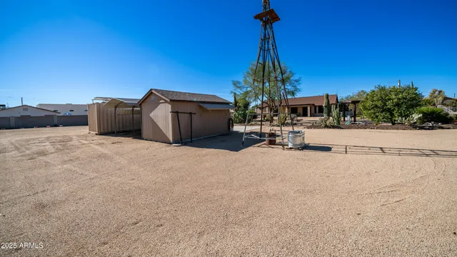 a view of a house with a road and a building