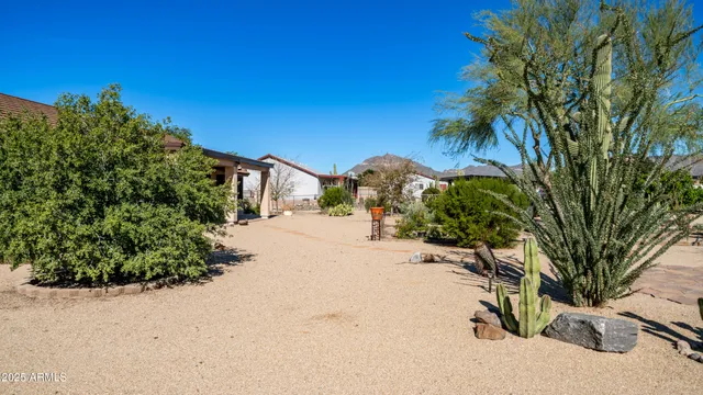 an aerial view of a house with a yard and parking
