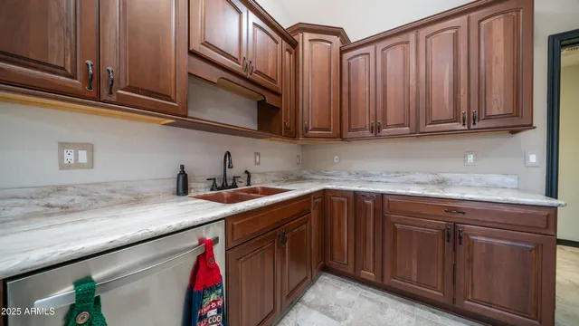 a kitchen with stainless steel appliances granite countertop a sink dishwasher stove and cabinets with wooden floor