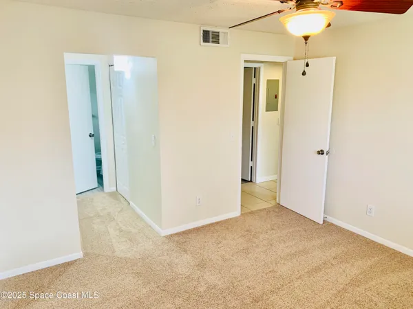 a white toilet sitting next to a shower