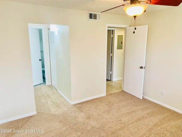 a white toilet sitting next to a shower