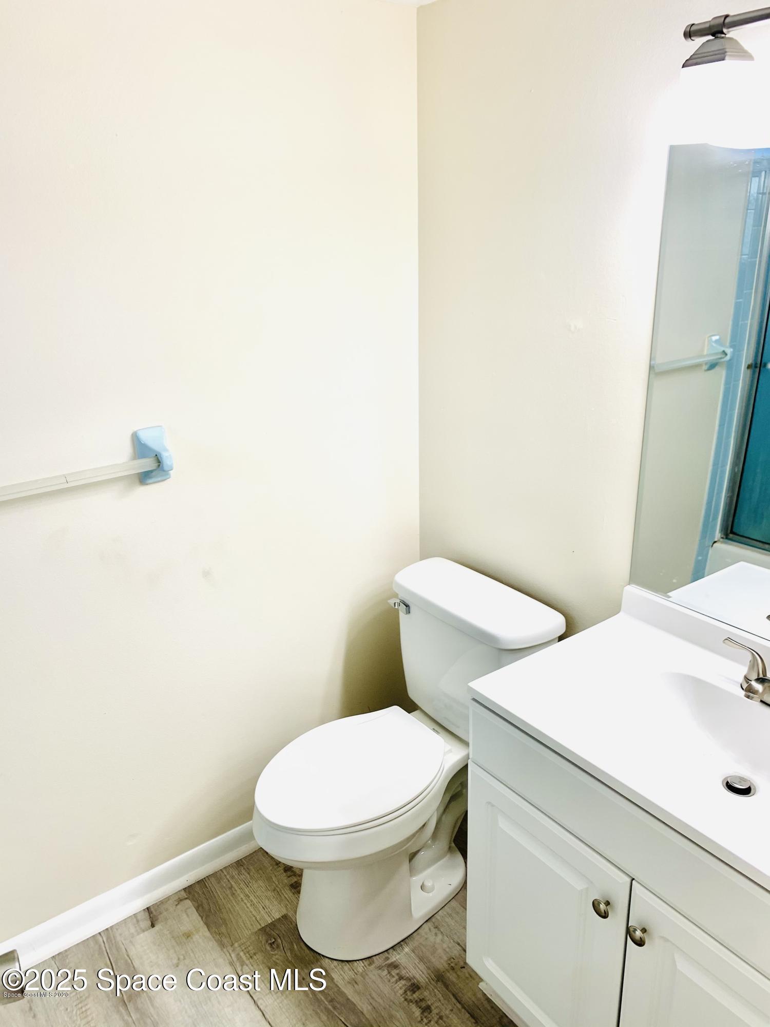 1648 Sunny Brook Lane, Unit M202 Palm Bay, FL 32905 - Photo 12 of 15 a white toilet sitting next to a shower