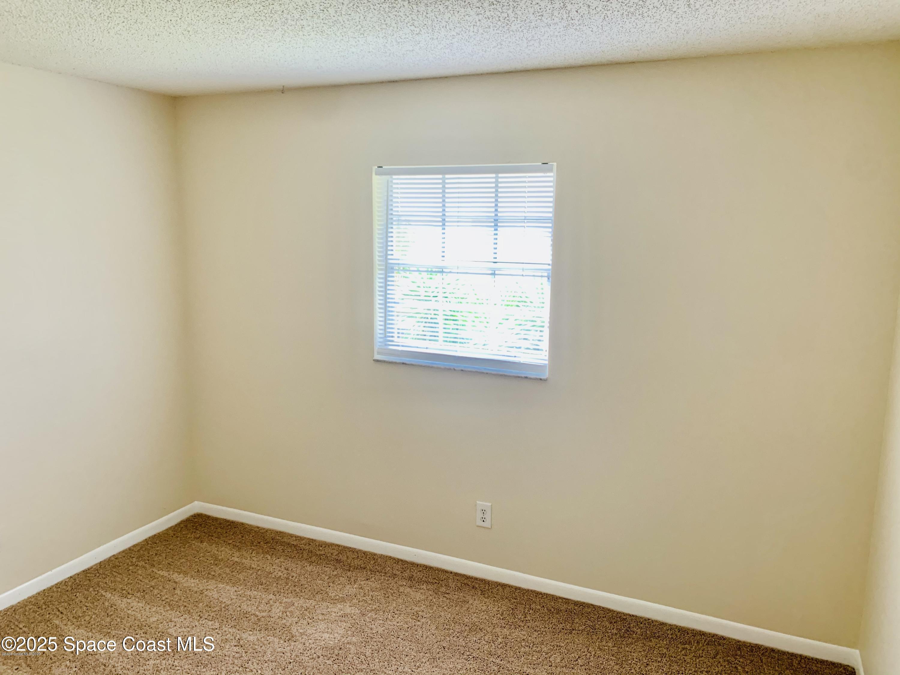 1648 Sunny Brook Lane, Unit M202 Palm Bay, FL 32905 - Photo 8 of 15 an empty room with a window