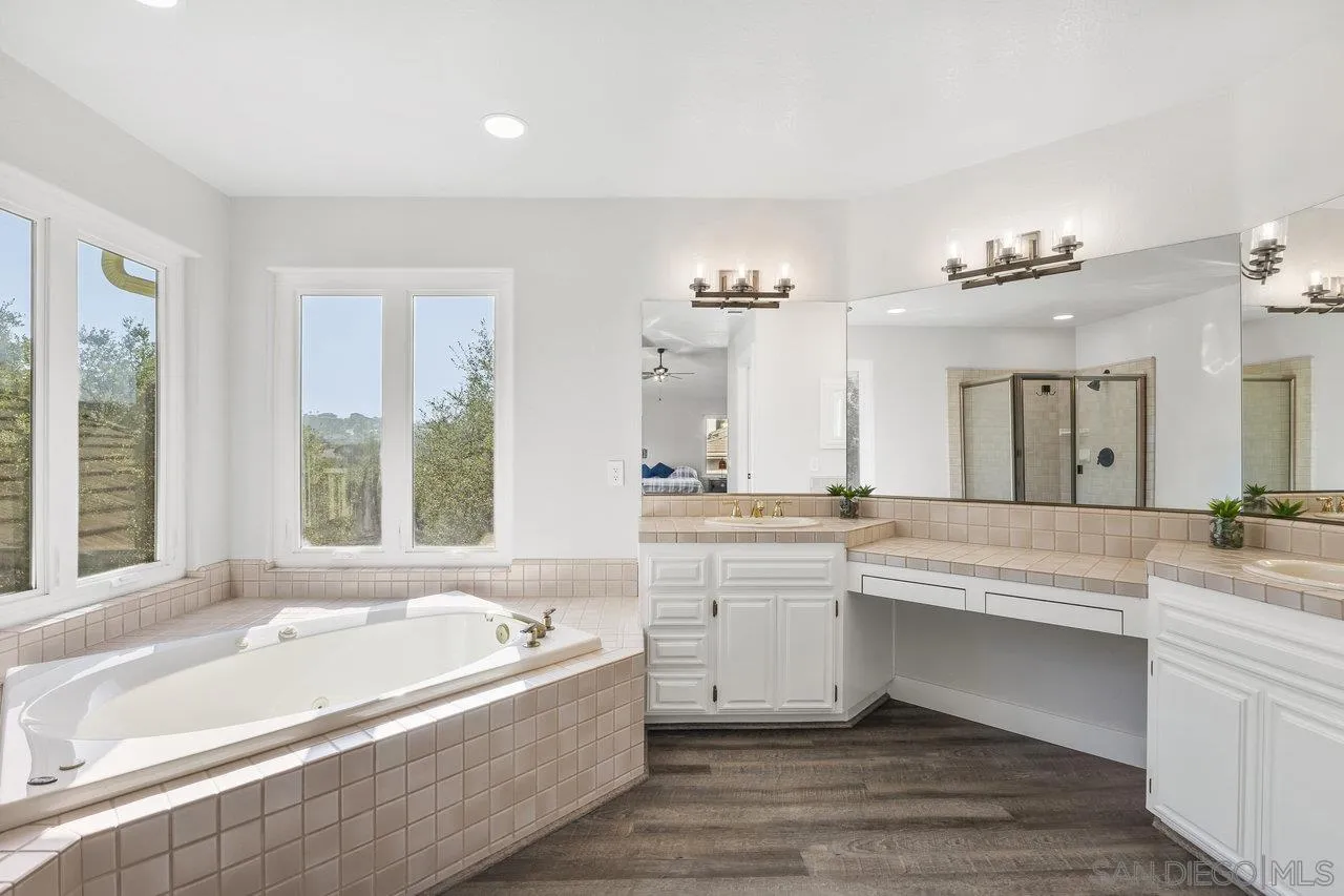 15931 Litten Way Ramona, CA 92065 - Photo 22 of 43 a large spacious bathroom with a large tub and large windows