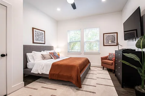 a bedroom with a bed and a desk