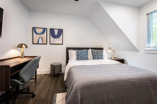 a bedroom with a bed and a window