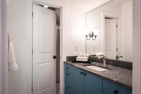 a bathroom with a sink a toilet and a shower