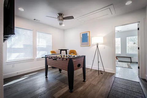 a view of a hallway with wooden floor and staircase