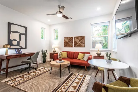 a living room with furniture and wooden floor
